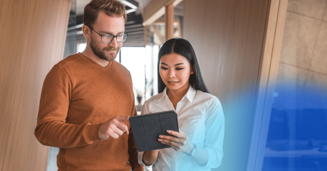 man and woman looking at document in an office 